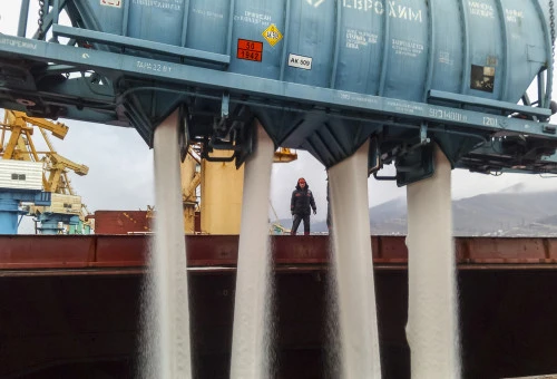 Novorossiysk, Russia - August 11, 2017: spillage of saltpeter from the car into the hold of the tanker. Loading of mineral fertilizers in the ship's hold.